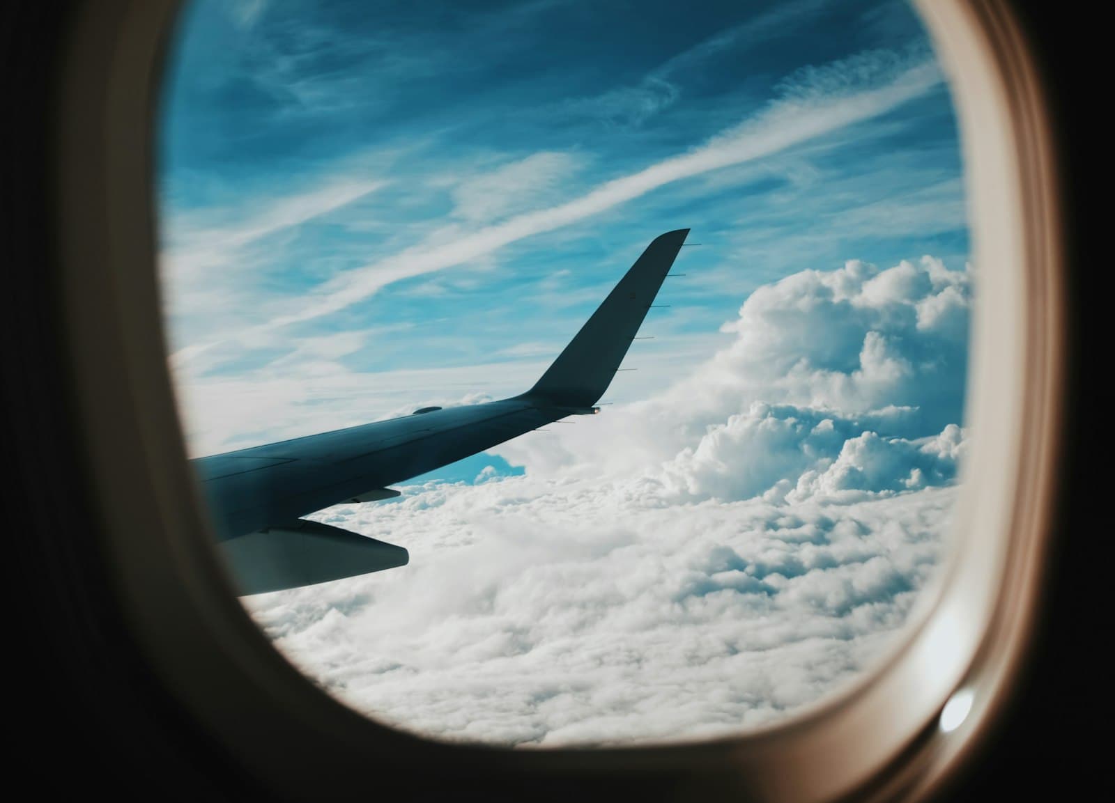 Airplane wing seen through a cabin window