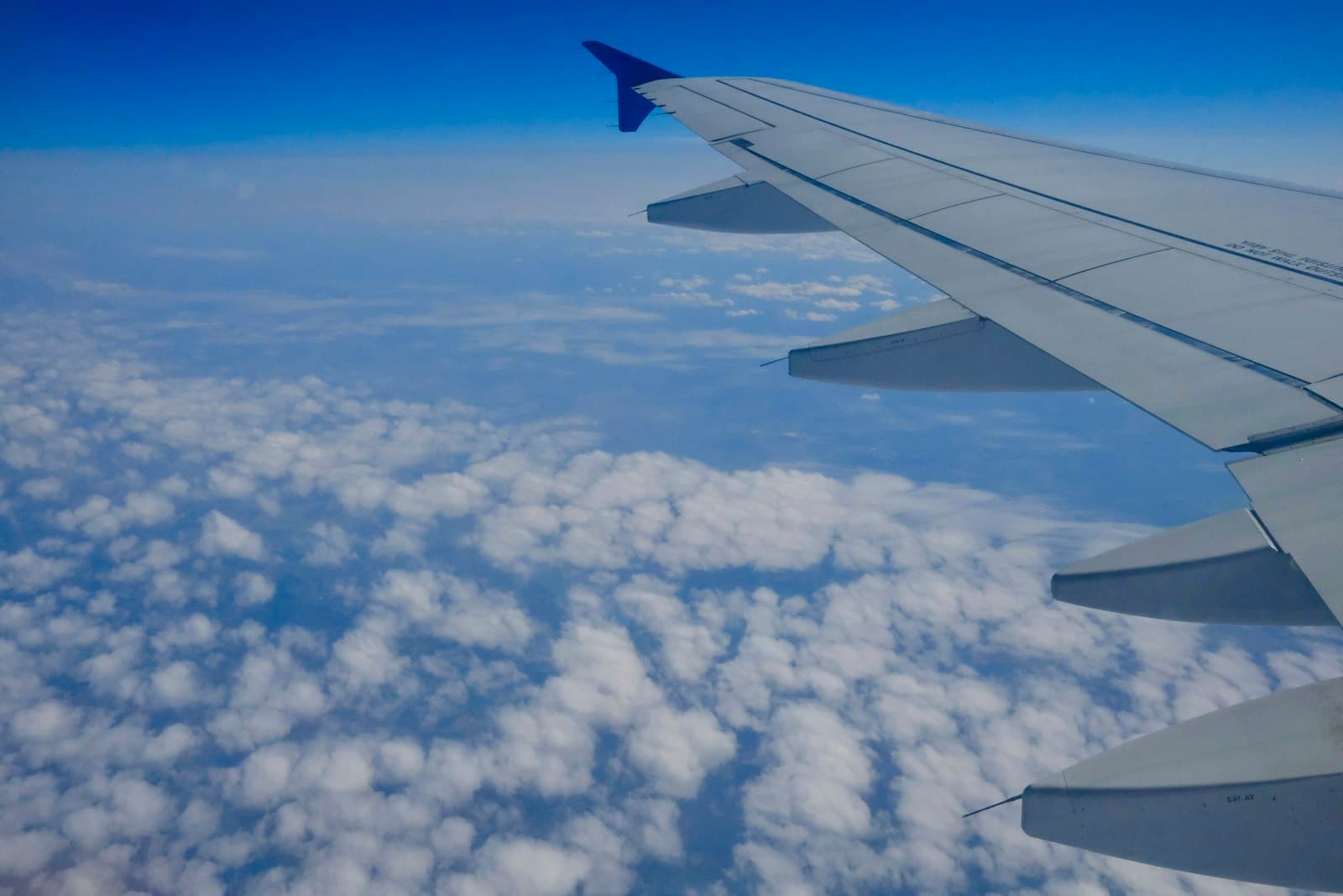 Airplane wing over the clouds